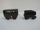 two toy trains sitting on a table next to each other