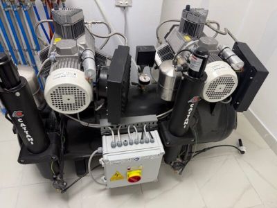 four air compressors sitting on top of each other in a room