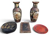three vases and a plate are sitting next to each other