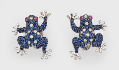 a pair of blue and white diamond frog earrings