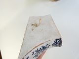 a hand holding a piece of paper that has a picture of a bird on it