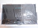a box with a laptop inside of it that is wrapped in plastic