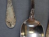 three spoons and two spoon spoons on a table