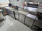 a view of a commercial kitchen with a lot of counter space