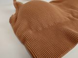 brown knitted tank top laying on a white surface