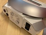 a silver toaster sitting on top of a table next to a laptop