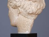 an image of a marble head of a woman on a black stand