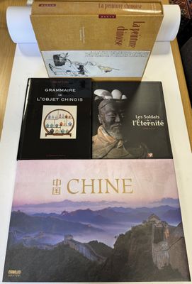 two books on a table with a box of books