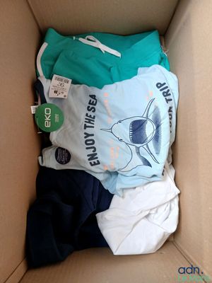 a cardboard box filled with clothes and a t - shirt