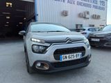 l'avant d'une Citroën argentée garée devant un immeuble