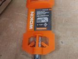 a small orange tool on the floor next to a box