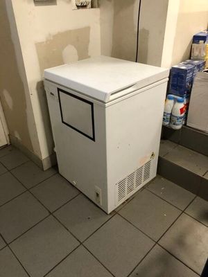 an image of a small white refrigerator in a kitchen