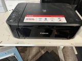 two pictures of a canon printer sitting on top of a table