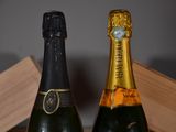 two bottles of champagne sitting next to each other on a table