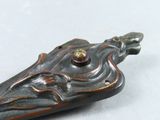 a close up of a metal object on a white surface