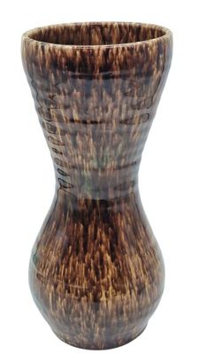 a brown vase that is sitting on a white surface