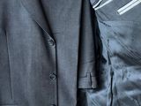 a man wearing a suit and tie with a pocket