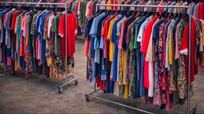 a lot of clothes hanging on a rack in a store