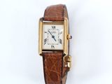 a close up of a wrist watch with a brown leather band