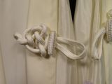 a close up of a curtain with a knot on it
