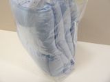a bag of blue cloths sitting on a white table
