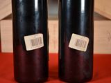 two bottles of wine sitting on a table with a barcode on them