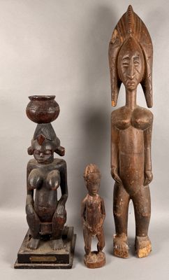 two wooden statues of a man and a woman and a child