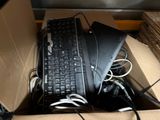a box with a keyboard, mouse, and headphones in it
