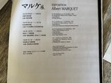 a menu on the table next to a cup of coffee