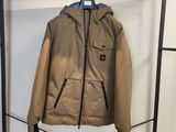 une veste marron accrochée à un porte-manteau dans une pièce