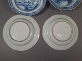 three blue and white plates with designs on them on a table