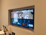 a flat screen tv mounted on a wall in a living room