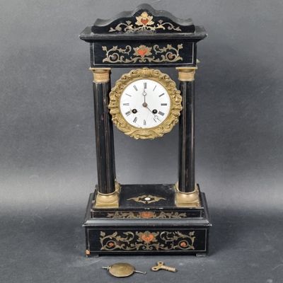 a black and gold clock sitting on a table