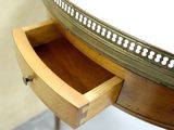 a small wooden table with a drawer underneath it