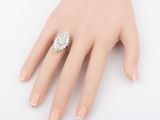 an image of a woman ' s hand with a diamond ring on it