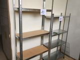 a room with a bunch of shelves and a refrigerator in it