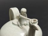 a small white object with two people on it