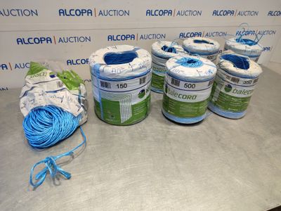 many rolls of blue and white yarn on a table