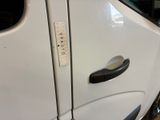 a close up of a door handle on a white truck