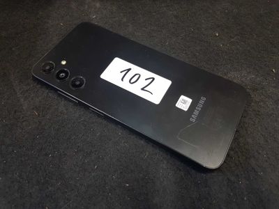 a close up of a cell phone on a black surface