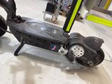 a scooter that is sitting on the floor in the garage