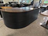 an image of an office with a curved desk in the middle