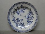 une assiette bleue et blanche ornée d'un motif floral
