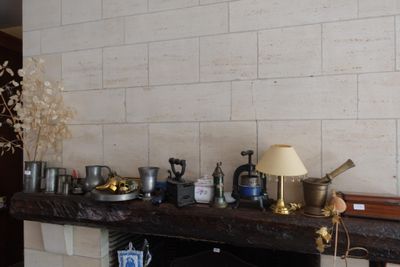 many pots and pans on the mantle of this room
