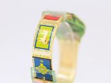 a close up of a bracelet with a picture on it