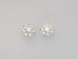 a pair of diamond earrings on a white background