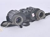 pair of black binoculars on white background with tags attached to them