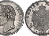 a close up of a silver coin with a crown on it