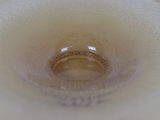 a close up of a wedding ring in a glass vase