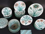 many plates and bowls that are sitting on a table